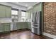 Stylish kitchen with stainless steel appliances and view of exposed brick wall at 434 E New York St, Indianapolis, IN 46202