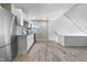This kitchen features white cabinets, stainless steel appliances, with wood look tile at 434 E New York St, Indianapolis, IN 46202