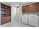 Well-organized laundry room with storage cabinets, a large window, and tile floors at 434 E New York St, Indianapolis, IN 46202