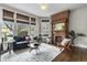 Inviting living room featuring a brick fireplace, large windows, and stylish furnishings at 434 E New York St, Indianapolis, IN 46202