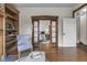 Bright living room features hardwood floors, built-in shelves, pocket doors and an archway to the bedroom at 434 E New York St, Indianapolis, IN 46202