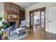 Charming living room with a brick fireplace, hardwood floors, and access to bedroom at 434 E New York St, Indianapolis, IN 46202