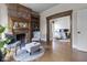 Comfortable living room with a brick fireplace, hardwood floors, and open access to bedroom at 434 E New York St, Indianapolis, IN 46202