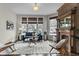 Bright living room featuring a brick fireplace, large windows, and stylish seating at 434 E New York St, Indianapolis, IN 46202