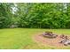 Private backyard featuring a brick fire pit and wooded views at 4743 Little Hurricane Rd, Martinsville, IN 46151