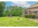 Spacious backyard with lush green grass, mature trees, and a playset at 4743 Little Hurricane Rd, Martinsville, IN 46151