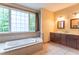 Luxurious bathroom features a soaking tub, double vanities, and ample natural light at 4743 Little Hurricane Rd, Martinsville, IN 46151