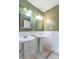 Bathroom featuring dual pedestal sinks with decorative mirrors, and white wainscoting at 4743 Little Hurricane Rd, Martinsville, IN 46151