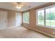Bright bedroom featuring neutral carpet and walls, a ceiling fan, and two large windows at 4743 Little Hurricane Rd, Martinsville, IN 46151
