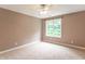 Bedroom with neutral carpet and walls with a large window and a ceiling fan at 4743 Little Hurricane Rd, Martinsville, IN 46151