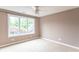 Bright bedroom features neutral walls, ceiling fan, and large window offering plenty of natural light at 4743 Little Hurricane Rd, Martinsville, IN 46151