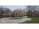 Classic brick home with a circular drive, mature trees, and attached garage at 4743 Little Hurricane Rd, Martinsville, IN 46151