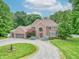 Traditional brick home featuring an oversized front lawn, circular driveway, and mature trees at 4743 Little Hurricane Rd, Martinsville, IN 46151