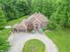 Traditional brick home featuring an oversized front lawn, circular driveway, and mature trees at 4743 Little Hurricane Rd, Martinsville, IN 46151