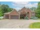 Charming brick home featuring a three-car garage and professionally landscaped front yard at 4743 Little Hurricane Rd, Martinsville, IN 46151