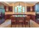 A kitchen with wooden cabinets, granite counters, an island, and a window that provides natural light at 4743 Little Hurricane Rd, Martinsville, IN 46151