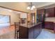 View of a kitchen, featuring brown cabinets, granite countertops, and a kitchen island with chairs at 4743 Little Hurricane Rd, Martinsville, IN 46151