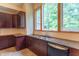 Kitchen with brown cabinets, granite counters, stainless appliances and a large arched window letting in lots of light at 4743 Little Hurricane Rd, Martinsville, IN 46151