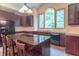 Kitchen with brown cabinets, granite counters, stainless appliances and a large arched window letting in lots of light at 4743 Little Hurricane Rd, Martinsville, IN 46151