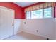 A laundry room with white walls and tile floors, with a window that provides natural light at 4743 Little Hurricane Rd, Martinsville, IN 46151