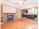 Living room with hardwood floors, a fireplace, and a view of the kitchen through an arched doorway at 4743 Little Hurricane Rd, Martinsville, IN 46151