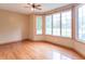 A living room with hardwood floors, neutral walls, a ceiling fan, and a bay window with backyard views at 4743 Little Hurricane Rd, Martinsville, IN 46151
