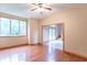 Living room with hardwood floors, a fireplace, large windows, and a doorway leading to another room at 4743 Little Hurricane Rd, Martinsville, IN 46151