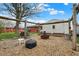 Backyard with wooden swing set and gravel area provides an entertainment space at 5440 Maplewood Dr, Indianapolis, IN 46224
