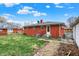 Brick home backyard with an air conditioning unit and detached garage at 5440 Maplewood Dr, Indianapolis, IN 46224