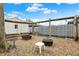 Gravel backyard with wooden swing set and fire pit, ideal for entertaining at 5440 Maplewood Dr, Indianapolis, IN 46224