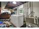 Unfinished basement with washer, dryer and utility sink at 5440 Maplewood Dr, Indianapolis, IN 46224