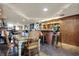 Finished basement with a bar, seating, tables, and other decor at 5440 Maplewood Dr, Indianapolis, IN 46224