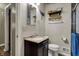 Bathroom featuring a vanity, sink, mirror, and toilet with a decorative shelf at 5440 Maplewood Dr, Indianapolis, IN 46224