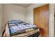 Bedroom featuring a colorful quilt on the bed and a closet with wooden sliding doors at 5440 Maplewood Dr, Indianapolis, IN 46224