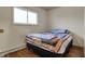 Bright bedroom with a full-sized bed, hardwood flooring, and a radiator at 5440 Maplewood Dr, Indianapolis, IN 46224