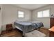 Bright bedroom with two windows, hardwood floors, and neutral paint at 5440 Maplewood Dr, Indianapolis, IN 46224
