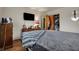 Comfortable bedroom featuring a dresser, TV, hardwood floors, and closet with open doors at 5440 Maplewood Dr, Indianapolis, IN 46224
