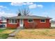 Charming single-story brick home with a well-maintained yard, under a bright sky at 5440 Maplewood Dr, Indianapolis, IN 46224