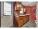 Bright kitchen area featuring wooden cabinets, laminate flooring, and a double basin sink at 5440 Maplewood Dr, Indianapolis, IN 46224