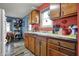 Functional kitchen with wood cabinets, contrasting wall colors, and essential appliances at 5440 Maplewood Dr, Indianapolis, IN 46224