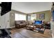 Bright living room featuring hardwood floors, comfortable seating, and natural light at 5440 Maplewood Dr, Indianapolis, IN 46224