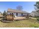 Backyard wooden deck with table, chairs, and grill, perfect for outdoor dining and entertaining at 546 Treyburn Lakes Way, Indianapolis, IN 46239
