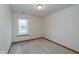 Modest bedroom features carpet, neutral walls, and a sun-filled window at 546 Treyburn Lakes Way, Indianapolis, IN 46239