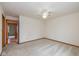 Spacious bedroom featuring neutral carpeting, a ceiling fan, and an open doorway at 546 Treyburn Lakes Way, Indianapolis, IN 46239
