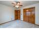 Bedroom with double closet and doorway to hall at 546 Treyburn Lakes Way, Indianapolis, IN 46239
