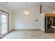 Dining area with a modern light fixture, tile flooring, and easy access to the kitchen at 546 Treyburn Lakes Way, Indianapolis, IN 46239