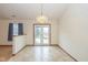 Bright dining room with sliding glass doors and modern light fixture at 546 Treyburn Lakes Way, Indianapolis, IN 46239