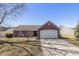 Charming red brick single-story home with attached two car garage and a well-manicured lawn at 546 Treyburn Lakes Way, Indianapolis, IN 46239
