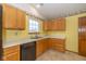 Functional kitchen featuring wooden cabinets, updated appliances, and a bright window at 546 Treyburn Lakes Way, Indianapolis, IN 46239