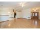 Open-concept living area with wood floors seamlessly connecting to the kitchen at 546 Treyburn Lakes Way, Indianapolis, IN 46239